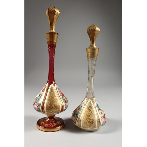 1072 - TWO BULBOUS OVERLAY SCENT BOTTLES AND STOPPERS, painted with flowers. 11ins and 9.5ins high.