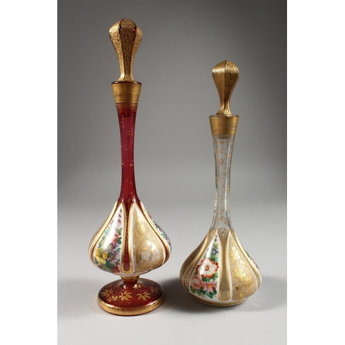 1072 - TWO BULBOUS OVERLAY SCENT BOTTLES AND STOPPERS, painted with flowers. 11ins and 9.5ins high.