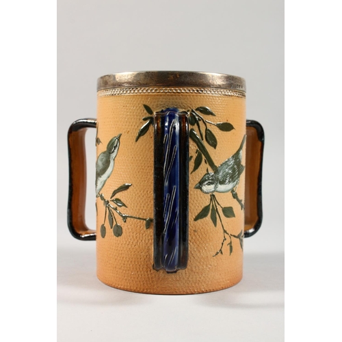 1077 - A GOOD DOULTON LAMBETH STONEWARE TYG by FLORENCE E. BARLOW decorated with birds. Maker F.E.B. Dated ... 