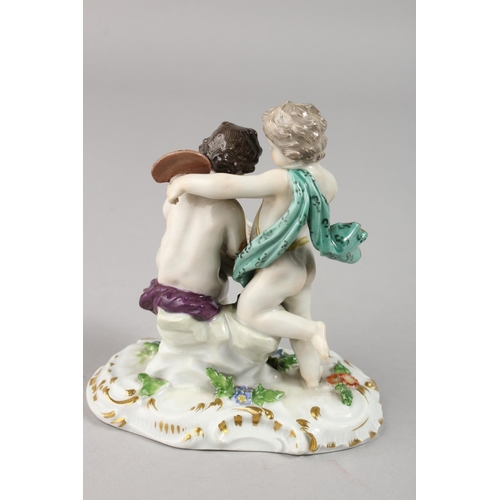 1116 - A 19TH CENTURY MEISSEN GROUP OF TWO PUTTI, Scribe. Cross swords mark in blue.  4.25ins high.