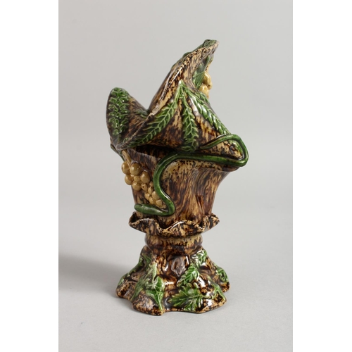 1128 - A SMALL MAJOLICA BROWN GLAZED VASE with fruiting vines. 7ins high.