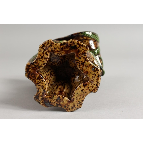 1128 - A SMALL MAJOLICA BROWN GLAZED VASE with fruiting vines. 7ins high.