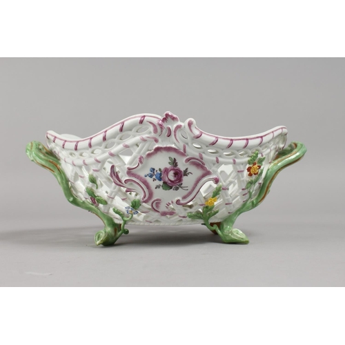 1133 - A GOOD MEISSEN OVAL PIERCED TWO-HANDLED BASKET, painted and encrusted with flowers with rustic handl... 