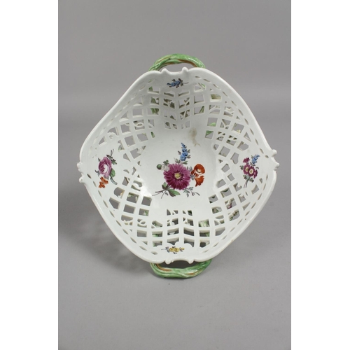 1133 - A GOOD MEISSEN OVAL PIERCED TWO-HANDLED BASKET, painted and encrusted with flowers with rustic handl... 