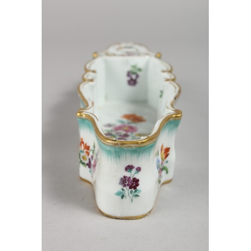 1139 - A RARE MEISSEN LONG INKWELL painted with flowers. Cross swords mark in blue.  10.75ins long.