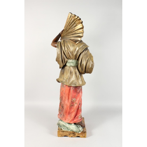 1149 - A LARGE ORIENTAL POTTERY STANDING FIGURE OF A MAN holding a large fan. 40ins high.