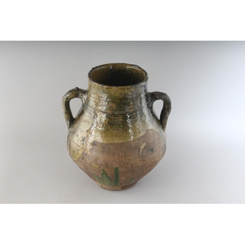 1150 - AN 18TH CENTURY TWIN HANDLED GREEN OCHRE GLAZED POT. 10.5ins high.