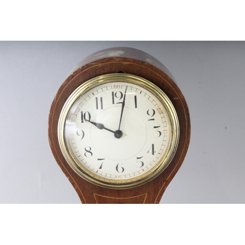 1192 - A SMALL EDWARDIAN MAHOGANY INLAID BALLOON SHAPED CLOCK on four brass ball feet. 8.5ins high.