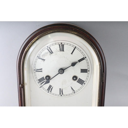 1193 - A 1930'S-1940'S MAHOGANY MANTLE CLOCK, with silvered dial on four bun feet. 11ins high.