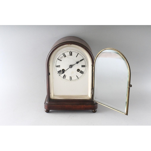 1193 - A 1930'S-1940'S MAHOGANY MANTLE CLOCK, with silvered dial on four bun feet. 11ins high.