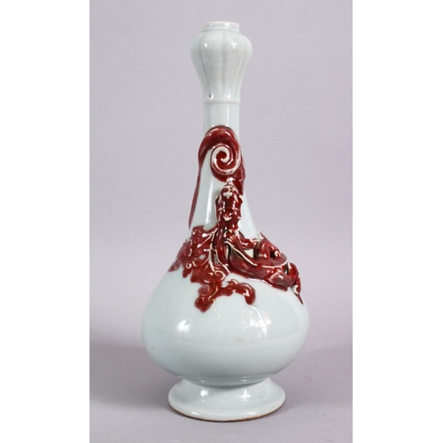 102 - A CHINESE COPPER RED GARLIC HEAD PORCELAIN CHILONG VASE, the monochrome body with iron red moulded c... 