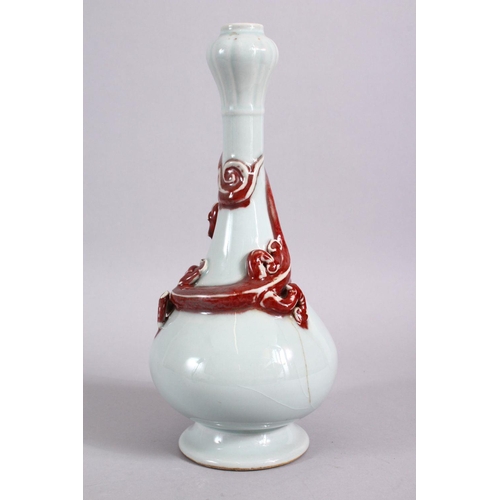 102 - A CHINESE COPPER RED GARLIC HEAD PORCELAIN CHILONG VASE, the monochrome body with iron red moulded c... 