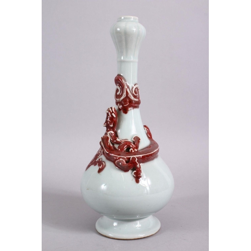 102 - A CHINESE COPPER RED GARLIC HEAD PORCELAIN CHILONG VASE, the monochrome body with iron red moulded c... 