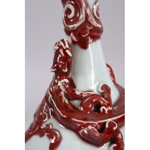 102 - A CHINESE COPPER RED GARLIC HEAD PORCELAIN CHILONG VASE, the monochrome body with iron red moulded c... 