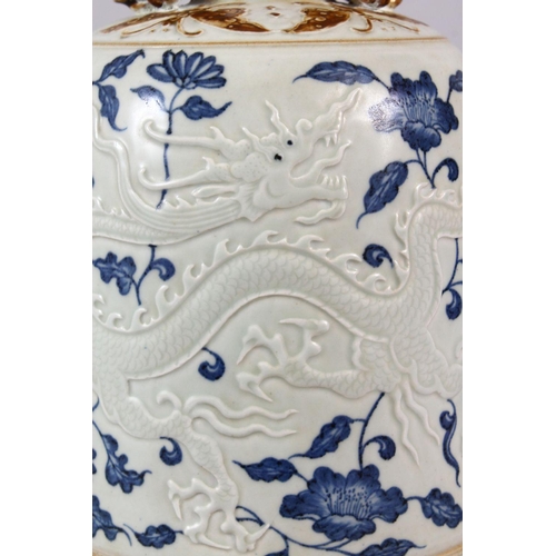 108 - A CHINESE BLUE, WHITE & BISCUIT MING STYLE DRAGON PORCELAIN TEMPLE BELL, the body with moulded relie... 