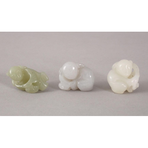 117 - THREE 19TH / 20TH CENTURY CHINESE CARVED WHITE / CELADON JADE FIGURES - BOYS, the carving depicting ... 