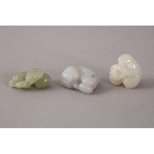 117 - THREE 19TH / 20TH CENTURY CHINESE CARVED WHITE / CELADON JADE FIGURES - BOYS, the carving depicting ... 