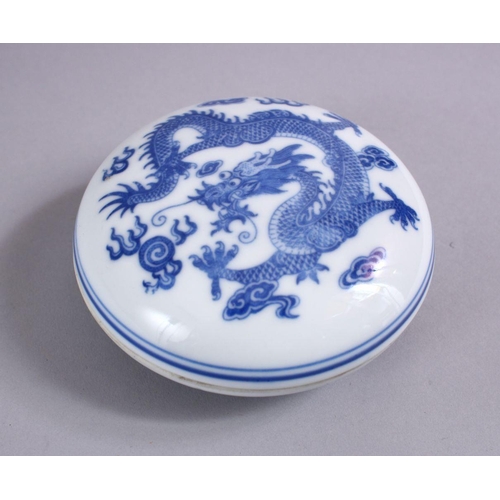 122 - A 19TH / 20TH CENTURY CHINESE BLUE & WHITE PORCELAIN BOX & COVER, decorated with scenes of a dragon ... 