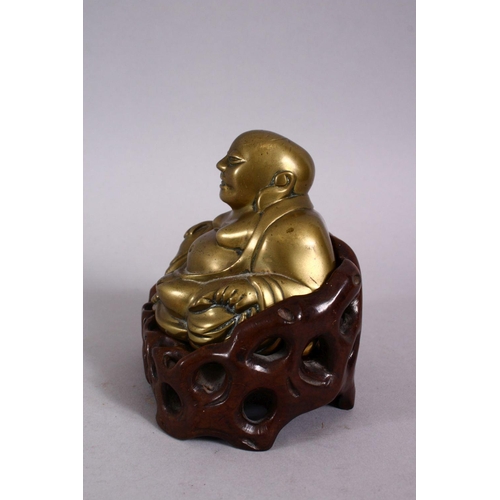 123 - A 19TH CENTURY CHINESE BRONZE FIGURE OF BUDDHA & STAND, seated with his hand upon his knee, in a car... 