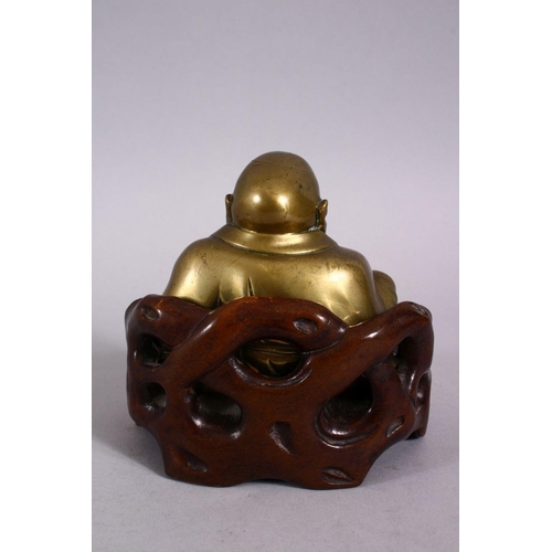 123 - A 19TH CENTURY CHINESE BRONZE FIGURE OF BUDDHA & STAND, seated with his hand upon his knee, in a car... 