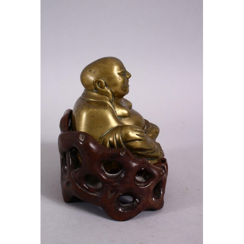 123 - A 19TH CENTURY CHINESE BRONZE FIGURE OF BUDDHA & STAND, seated with his hand upon his knee, in a car... 