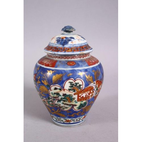 126 - AN 18TH CENTURY JAPANESE BLUE, WHITE AND IRON RED PORCELAIN ARITA JAR & COVER, with landscape views ... 