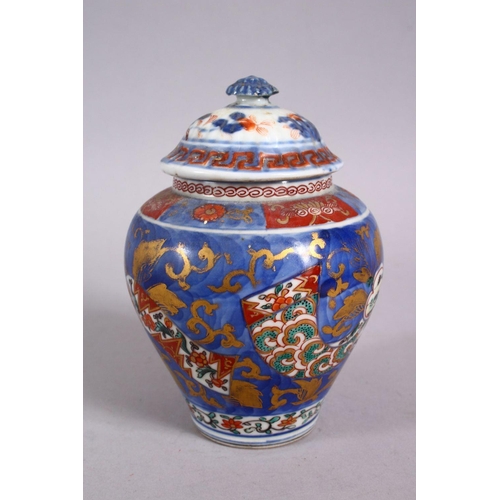 126 - AN 18TH CENTURY JAPANESE BLUE, WHITE AND IRON RED PORCELAIN ARITA JAR & COVER, with landscape views ... 