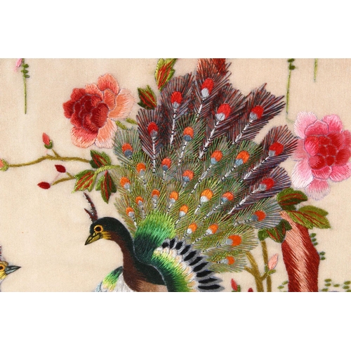 132 - 20TH CENTURY CHINESE SCHOOL, a silk embroidered picture depicting peacocks by a prunus tree, framed ... 