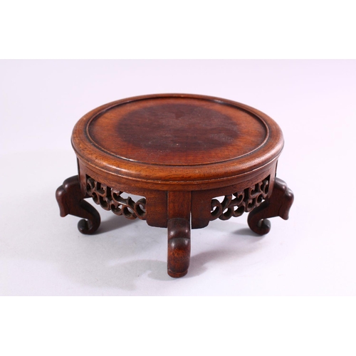 16 - A 19TH CENTURY CHINESE CARVED HARDWOOD STAND, with carved frieze and stood upon five feet, housing a... 