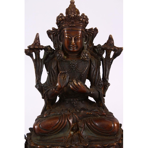 164 - A TIBETAN BRONZE FIGURE OF BUDDHA / DEITY, in a seated position upon a recumbent lion dog, upon a st... 