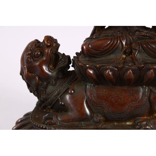 164 - A TIBETAN BRONZE FIGURE OF BUDDHA / DEITY, in a seated position upon a recumbent lion dog, upon a st... 