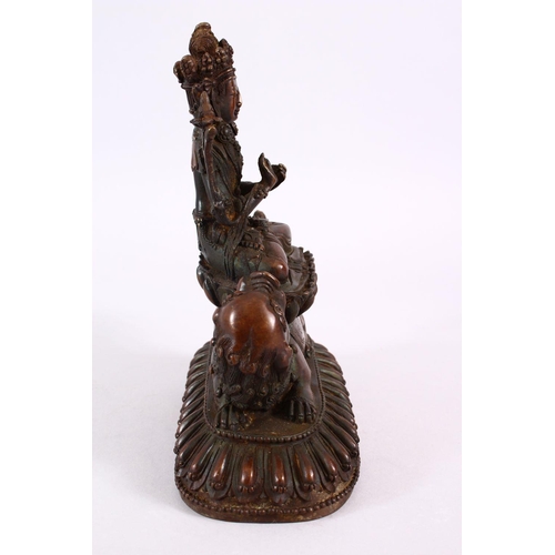 164 - A TIBETAN BRONZE FIGURE OF BUDDHA / DEITY, in a seated position upon a recumbent lion dog, upon a st... 