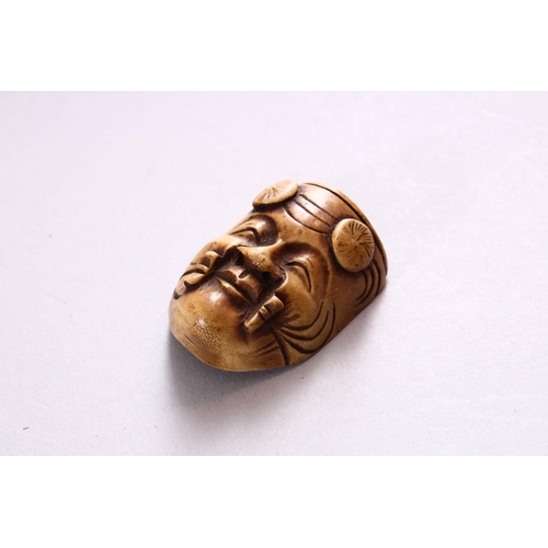 166 - A SMALL CARVED BONE NOH MASK, 3.5cm.