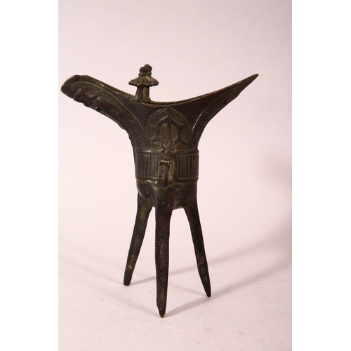 169 - A SMALL PAIR OF CHINESE ARCHAIC FORM CAST BRONZE TRIPOD CENSERS, 13cm.