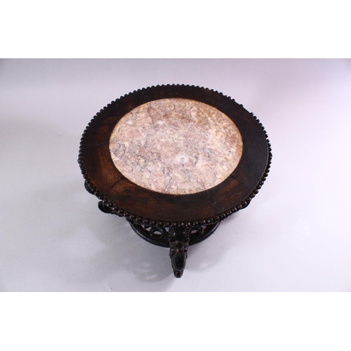 18 - A GOOD CHINESE CARVED HARDWOOD STAND, with inlaid marble top, 22cm high, 30cm diameter.