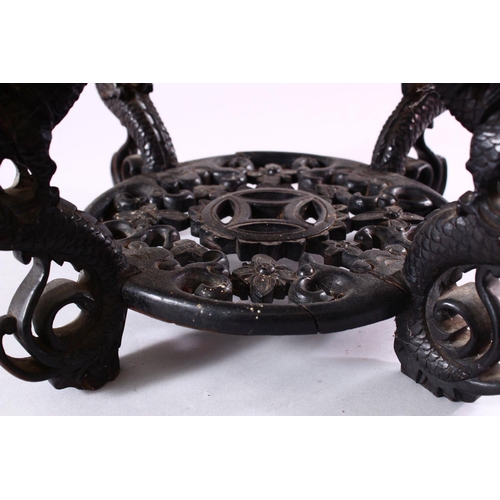 18 - A GOOD CHINESE CARVED HARDWOOD STAND, with inlaid marble top, 22cm high, 30cm diameter.