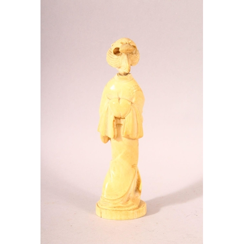 180 - AN EARLY 20TH CENTURY JAPANESE CARVED IVORY OKIMONO OF A GEISHA GIRL, mark to base, 20cm high.