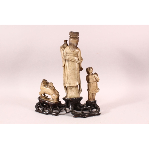 181 - A GOOD 18TH / 19TH CENTURY CHINESE SOAPSTONE GROUP, the central female figure holding an urn, a chil... 