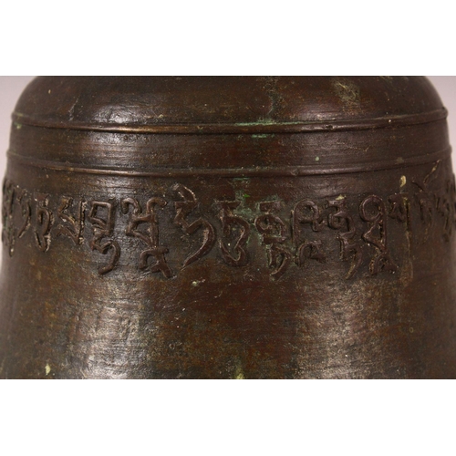 182 - A TIBETAN CAST BRONZE TEMPLE BELL, with a band of calligraphy to the exterior and a possible signatu... 