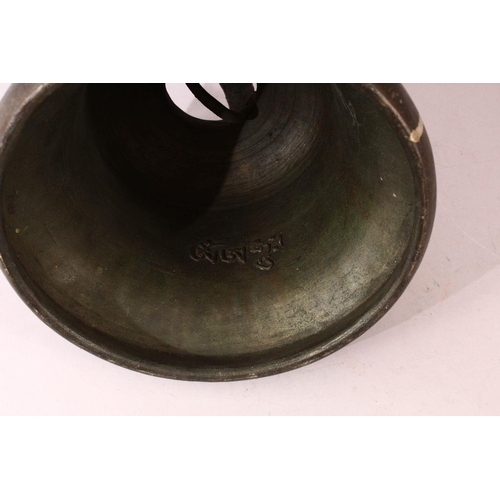 182 - A TIBETAN CAST BRONZE TEMPLE BELL, with a band of calligraphy to the exterior and a possible signatu... 