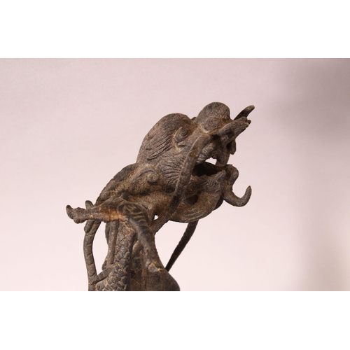 183 - A PAIR OF CHINESE CAST BRONZE DRAGONS, standing on their hind legs, 35cm high.