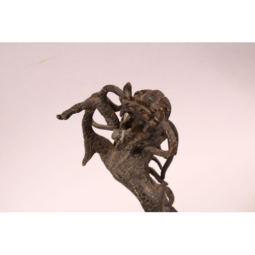 183 - A PAIR OF CHINESE CAST BRONZE DRAGONS, standing on their hind legs, 35cm high.