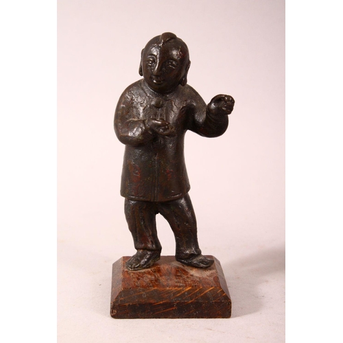 184 - A PAIR OF SMALL CHINESE CAST BRONZE FIGURES OF YOUNG BOYS, holding items in their hand, showing trac... 