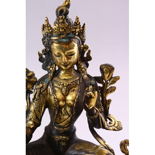 188 - A TIBETAN GILT BRONZE FIGURE OF A SEATED FEMALE DIETY, on lotus pad, 24cm high.