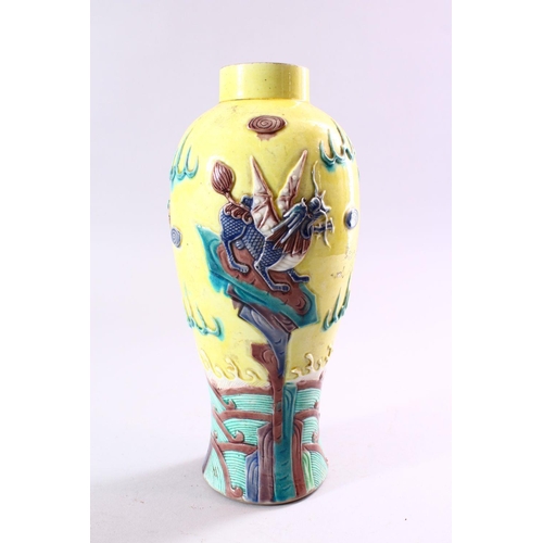 189 - A CHINESE FAMILLE JAUNE GROUND BALUSTER SHAPED VASE, with moulded decoration depicting stylised drag... 