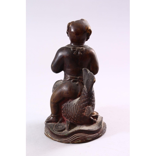 191 - A SMALL CHINESE BRONZE FIGURE OF A BOY SEATED UPON A CARP, 15cm high.