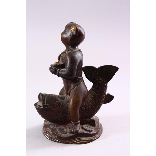 191 - A SMALL CHINESE BRONZE FIGURE OF A BOY SEATED UPON A CARP, 15cm high.