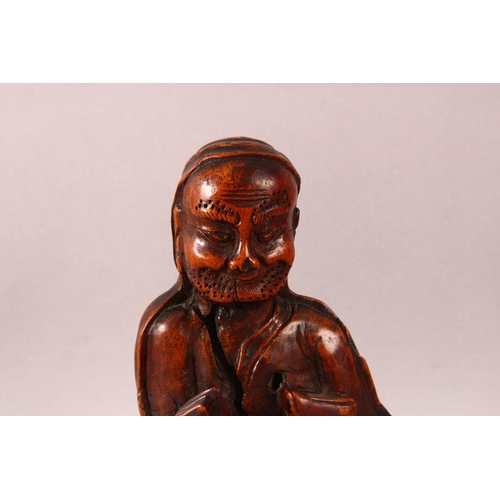 197 - A CHINESE CARVED ROOTWOOD FIGURE OF A SAGE, 29cm high.