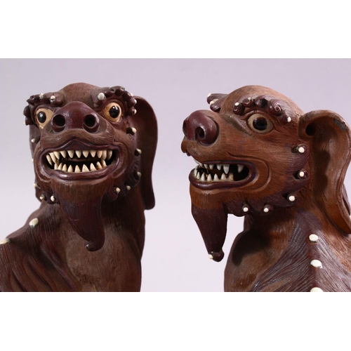 201 - A GOOD PAIR OF CHINESE 19TH CENTURY TERRACOTTA FORMED LION DOG FIGURES, the mirrored pair with glaze... 