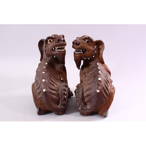 201 - A GOOD PAIR OF CHINESE 19TH CENTURY TERRACOTTA FORMED LION DOG FIGURES, the mirrored pair with glaze... 